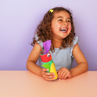 Child holding a colorful toy with a purple top against a light purple background