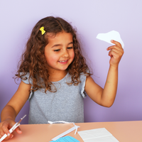 Young girl practicing her gross and fine motor skills with a My Mini Maker craft subscription box for kids