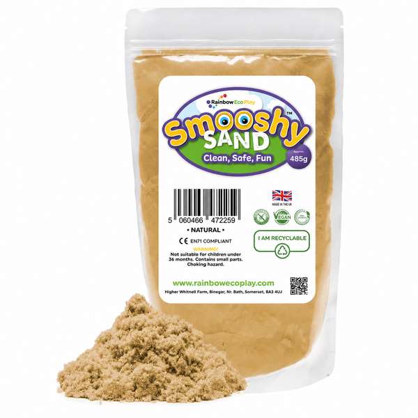 Bag of UK-made Smooshy Sand kinetic sensory sand with a pile of natural-coloured sand in front