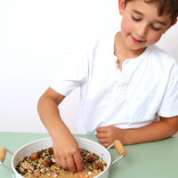 Child interacting with a woodland messy play tray, perfect calming kids activity
