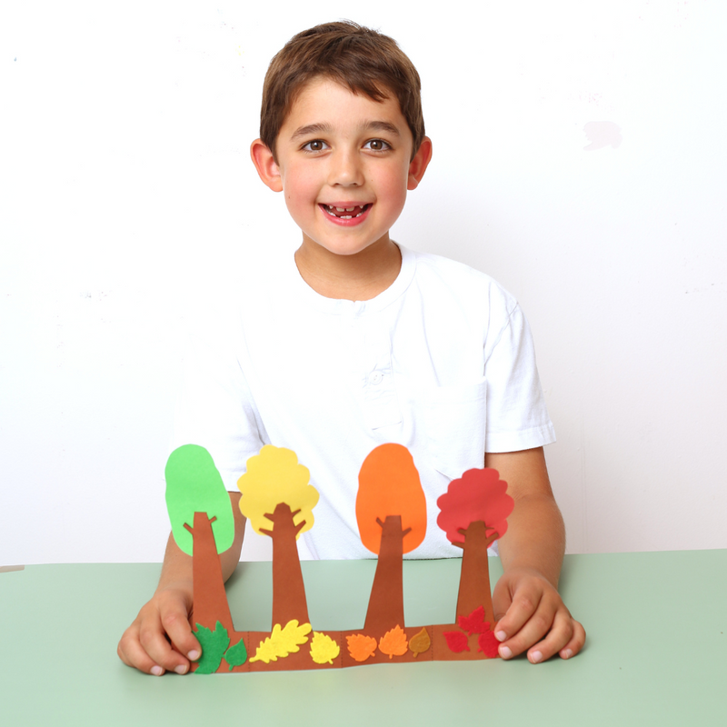 Boy age 7 playing with autumn craft kit UK, perfect kids activity