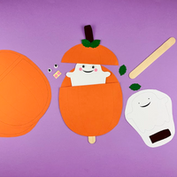 Ghost in a pumpkin craft: orange card pumpkin pieces with a smiling white ghost peeping out of the top, and a lolly stick to make the ghost pop up