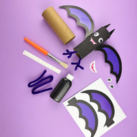 Wicked winged bat craft: a cardboard tube painted black with purple wings, googly eyes and fangs, shown with the black paint, brush, pipe cleaners and printed wing templates