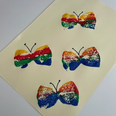 Butterfly stamping craft using a sponge tied with a rubber band and paint
