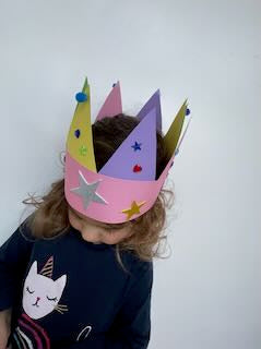 Finished paper crown with coloured triangles, gems and stickers