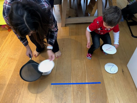 Numbered cardboard pancakes carried on a toy frying pan