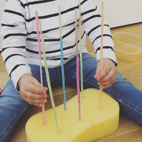 Sponge with wooden skewers and cut straw pieces ready for the sponge and sticks activity